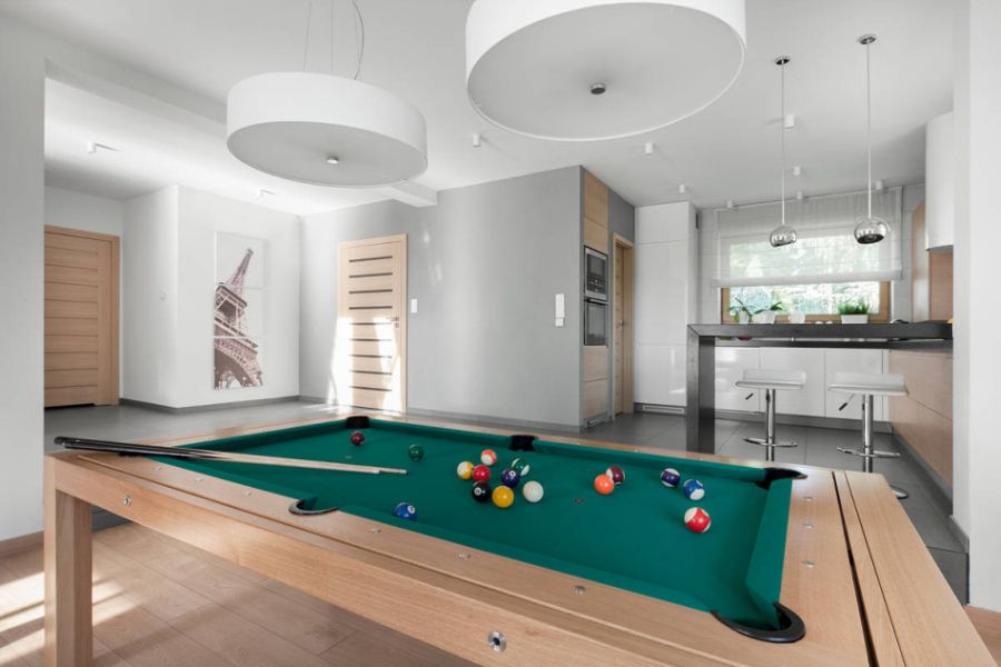 Large white pendants above the pool table