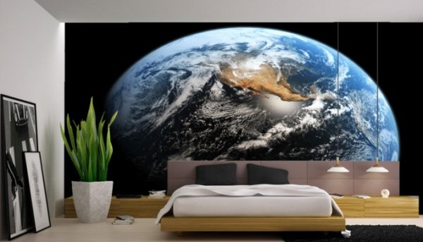 Minimalist bedroom with wall mural depicting a view of earth from space