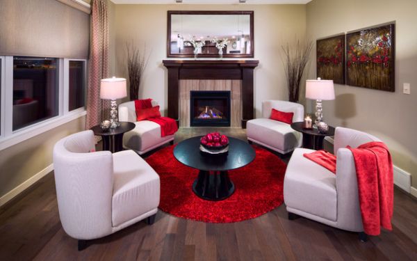 Living room with a black center table that has a fruit bowl with red fruits.