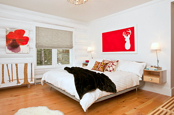 Red accents in a white bedroom