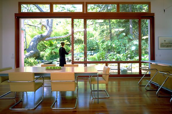 Simple dining area with a wood-top dining table that has a bowl of green apples.