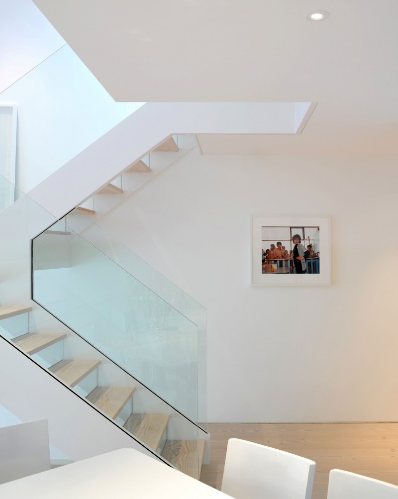 Staircase with glass railing makes an important addition to the Highgate home