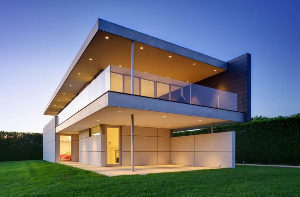 Verandas and eaves with recessed lighting give the facade a soft and inviting aura