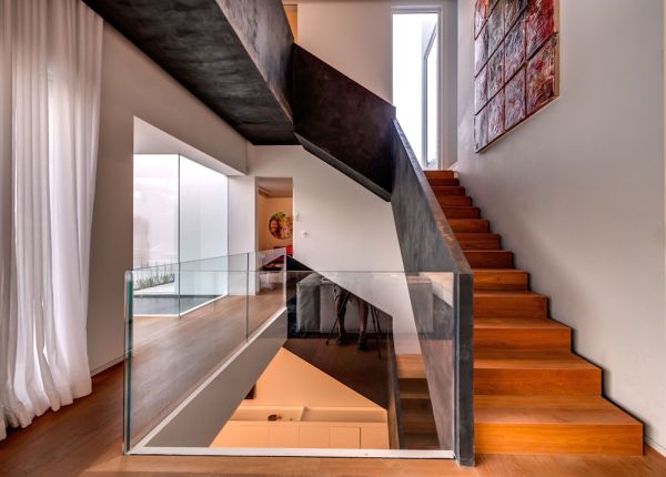 Wooden stairs with steel railing leads to the top level