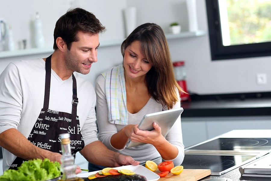 couple in the kitchen using tablet