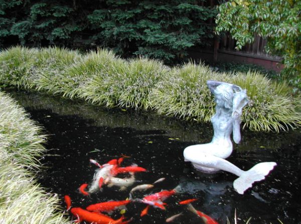 Add a central sculptural piece to your koi pond for more elegance