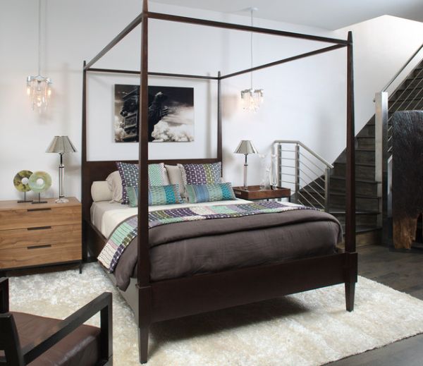 Carpet and four-poster help demarcate the bedroom in an open floor plan