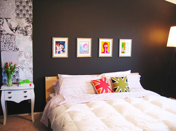 Colorful pillows and artwork in a dark bedroom