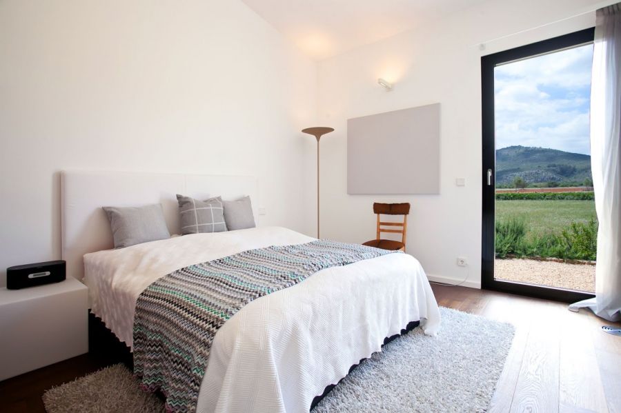 Exquisite bedroom in white at the holiday home in Mallorca by ecoDESIGNfinca