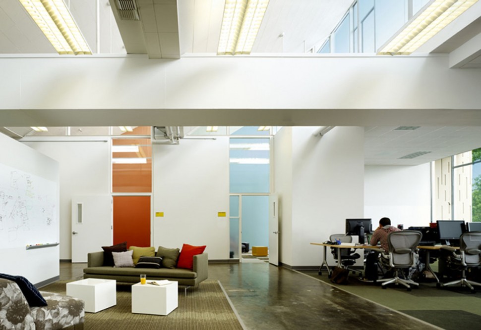 Two enclosed offices add splashes of color to open office and sitting area