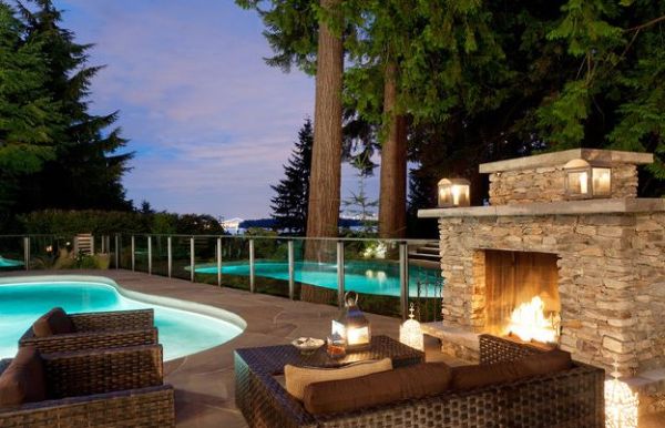 Gorgeous stone fireplace next to the pool