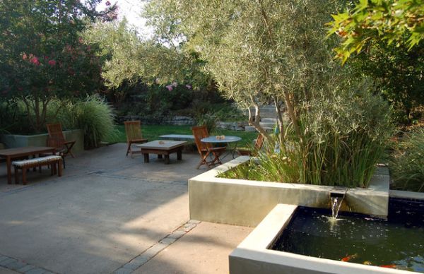 Low wide walls of the simple koi pond allow you to sit next to your finned friends!