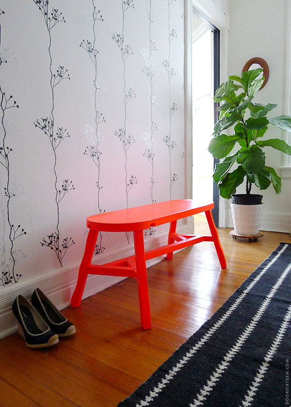 Neon orange bench in a modern hallway