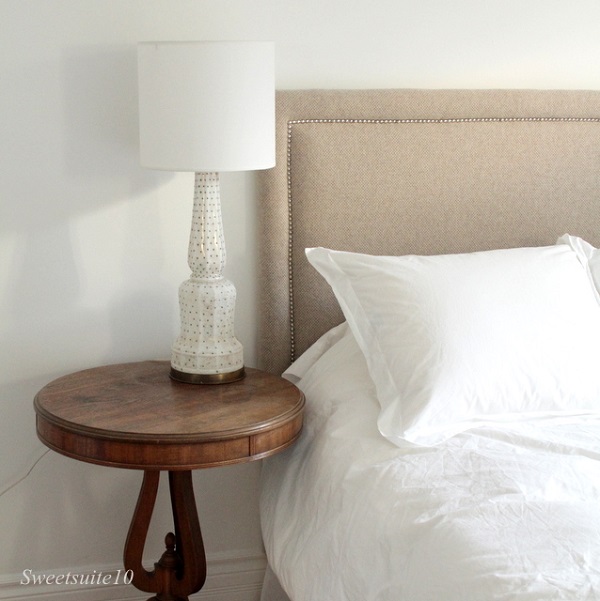 Oatmeal upholstered headboard with silver nailheads