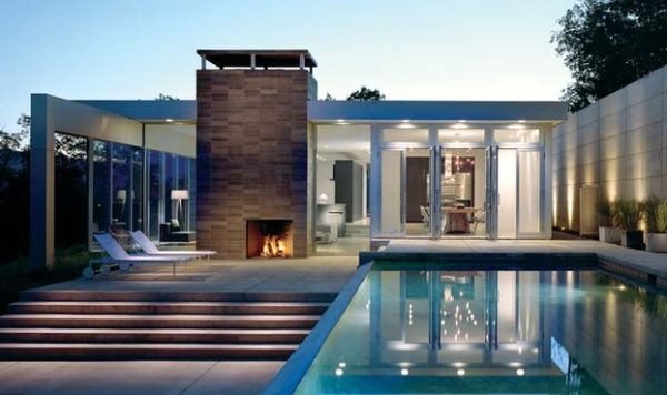 Outdoor fireplace next to the pool completes your patio or deck space