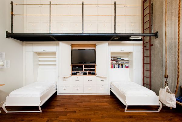 Savvy custom wall unit with integrated twin Murphy beds and storage units