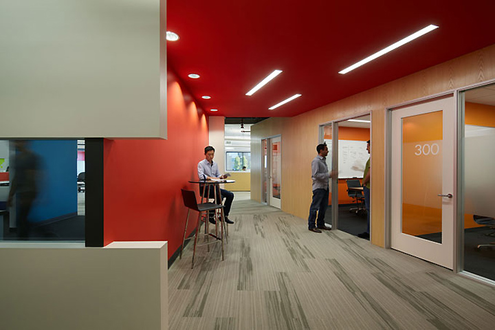 The orange tunnel with wood grain walls and white doors