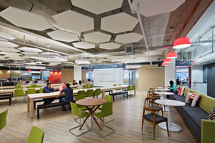 Green and charcoal upholstery with orange lamps in the cafeteria