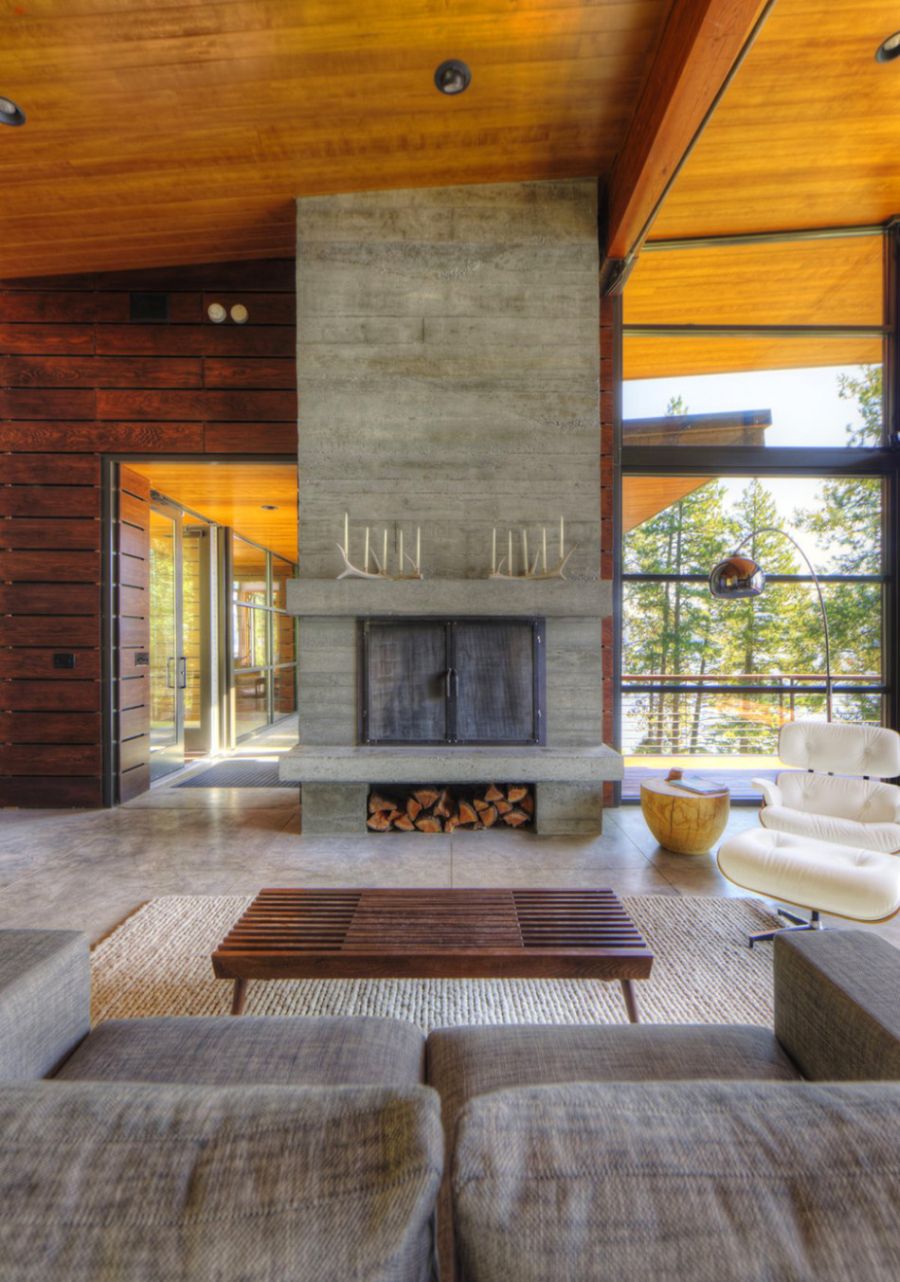 Stone fireplace with Eames Lounger next to it