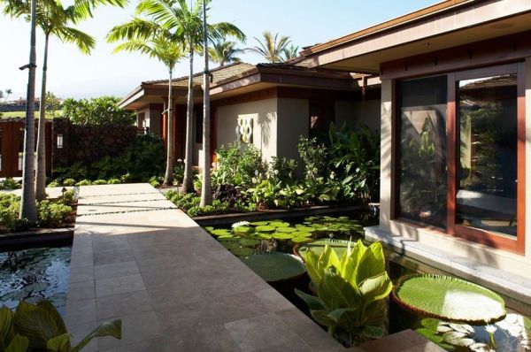 Tropical landscape with a koi pond and a broad walkway