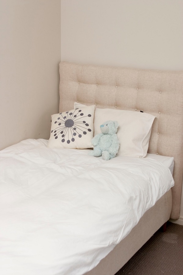 Tufted headboard upholstered in linen