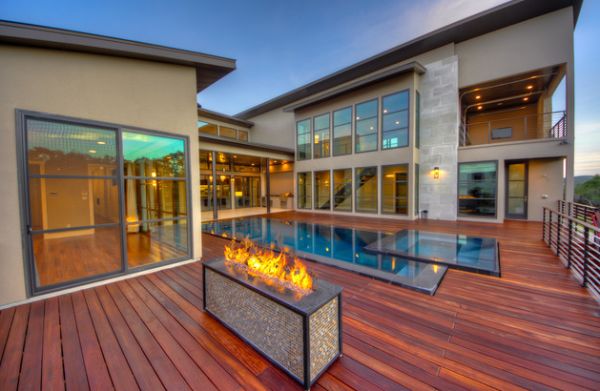 Wooden deck and fireplace add uniqueness to the pool area