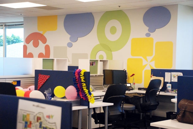 Dark cube walls and chairs provide a good contrast for the colorful wall via California Home and Design