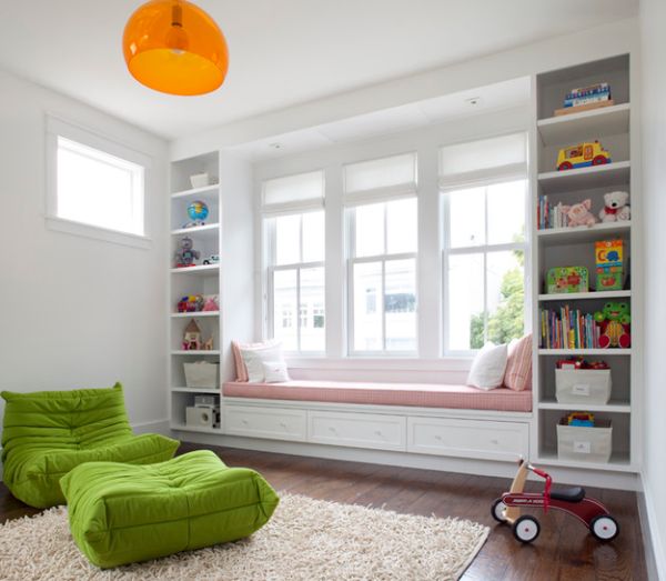 Apple green Togo Sofa coupled with bright orange FLY pendant