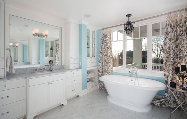 Bathroom in blue and white with toile fabric drapes that anchor the color scheme