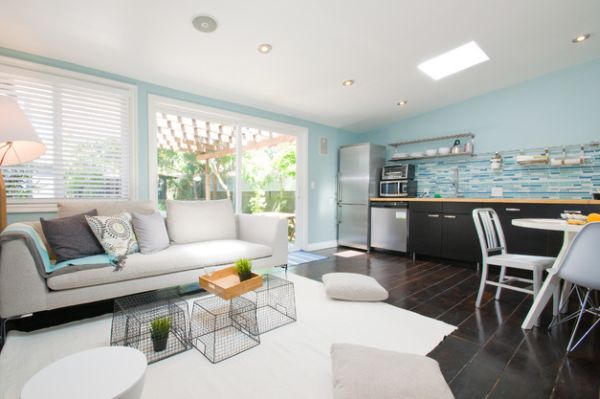 Contemporary living space with pristine white floor pillows - Those could take some washing!