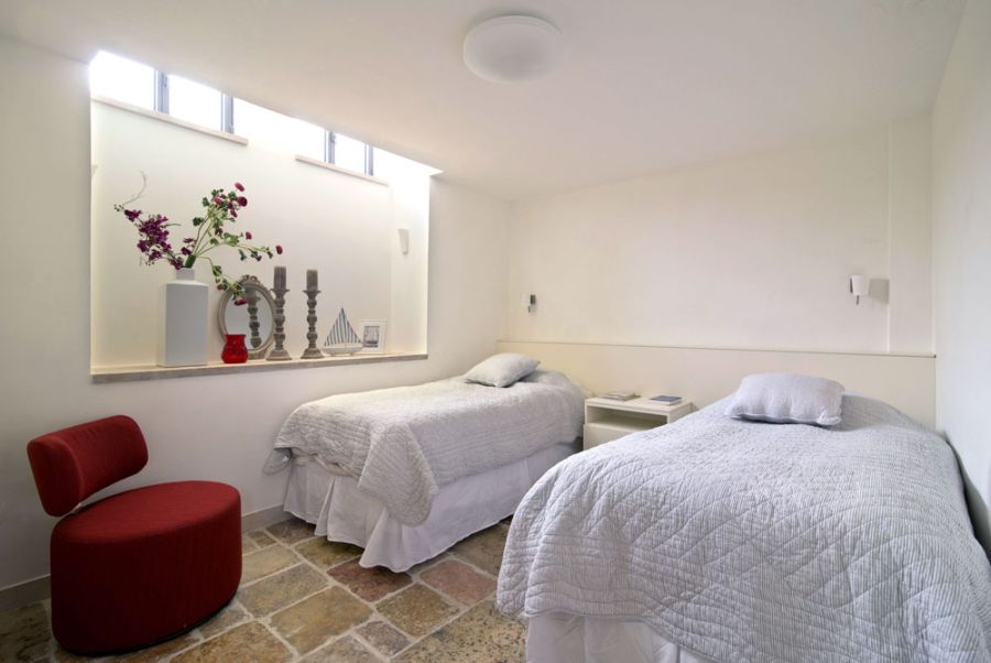 Guest bedroom in the basement in white