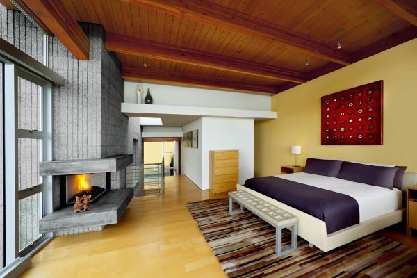 Interesting fireplace adds geometric variation to the bedroom