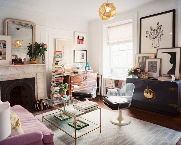 Living room with layers of artwork and stacks of books