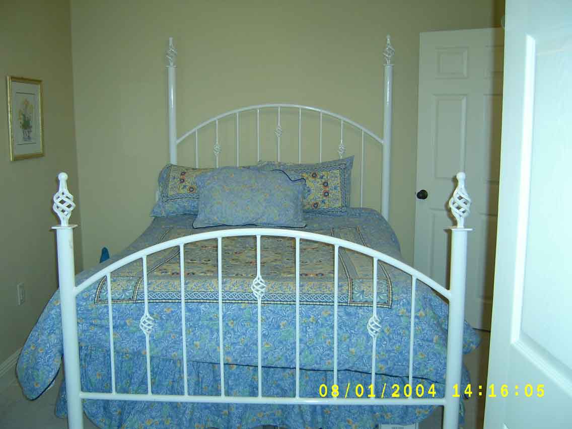 Metalcraft of Pensacola Antique Style Wrought Iron Bed with Light Blue Bedspread