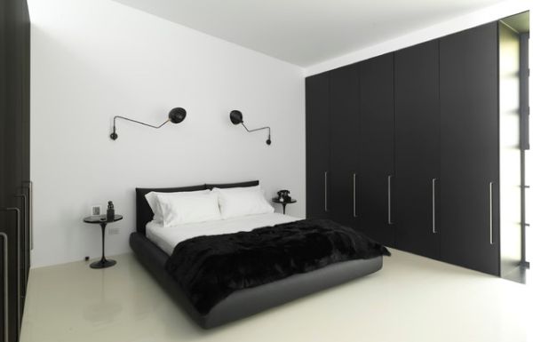 Minimalist bedroom in black and white accentuated by Serge Mouille Rotating Sconces