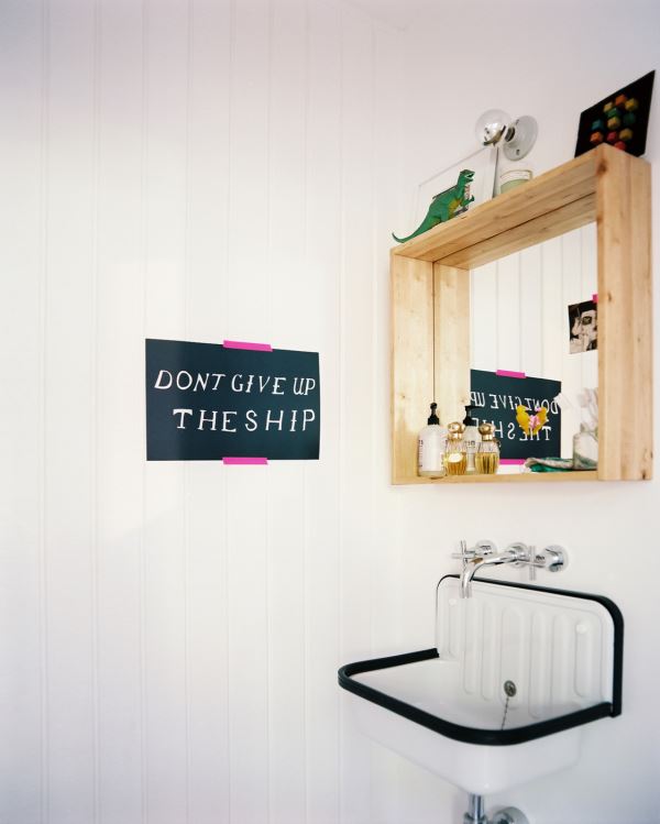 Mirror with ledge storage in an eclectic bathroom