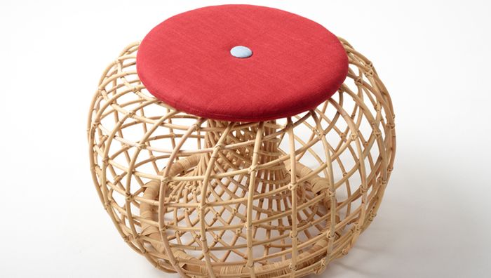Nest footstool with red cushion on top