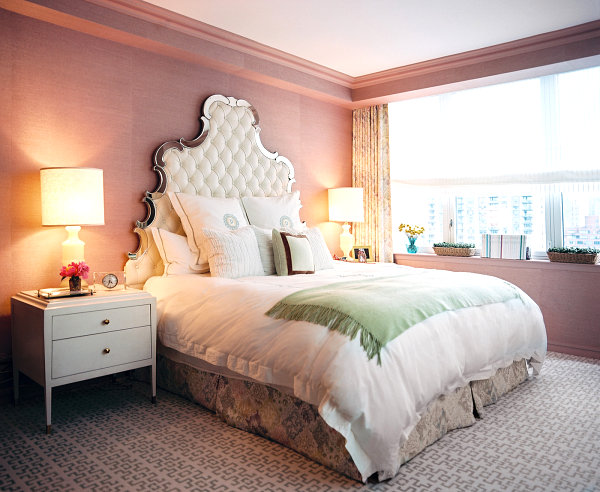 Ornate headboard in a rosy bedroom