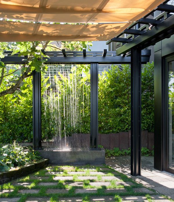 Rainwater channeled through pipes to create artificial waterfalls in the pergola