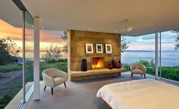 Stunning view combined with stone fireplace make a truly romantic bedroom