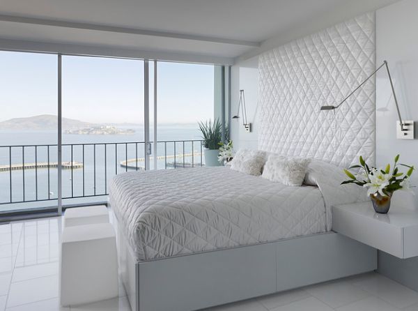 Stylish contemporary bedroom in white with sleek sconce lights