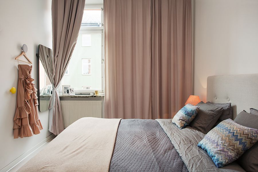 Throw pillows add blue hues to master bedroom