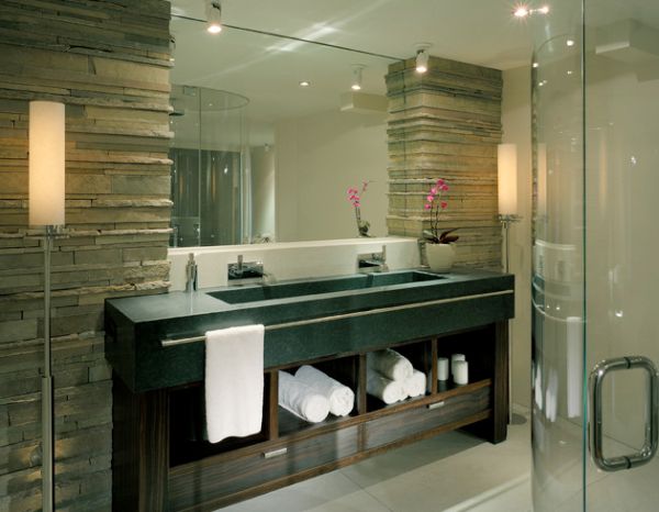 Towel display adds warm texture to the bathroom dominated by stone and wood