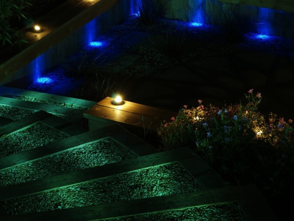 blue green and yellow lighting for dramatic effect in garden