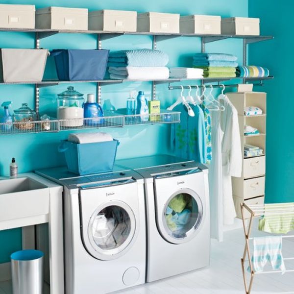 Blue laundry room wit plenty of shelf space