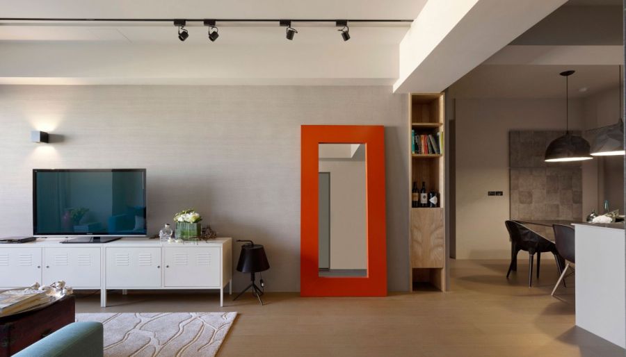 Bright orange mirror frame in the living room