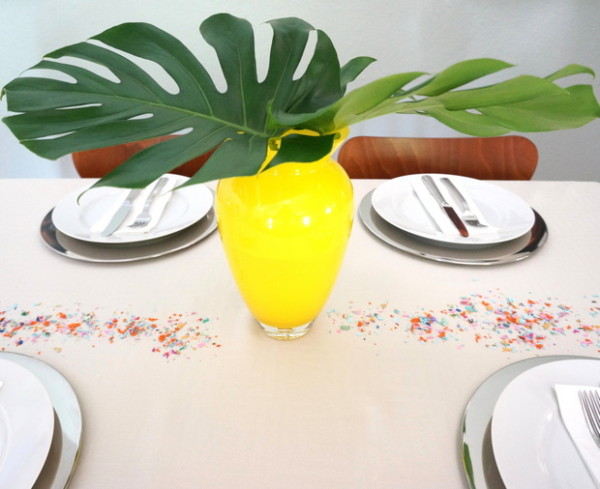 Monstera leaves in a yellow glass vase