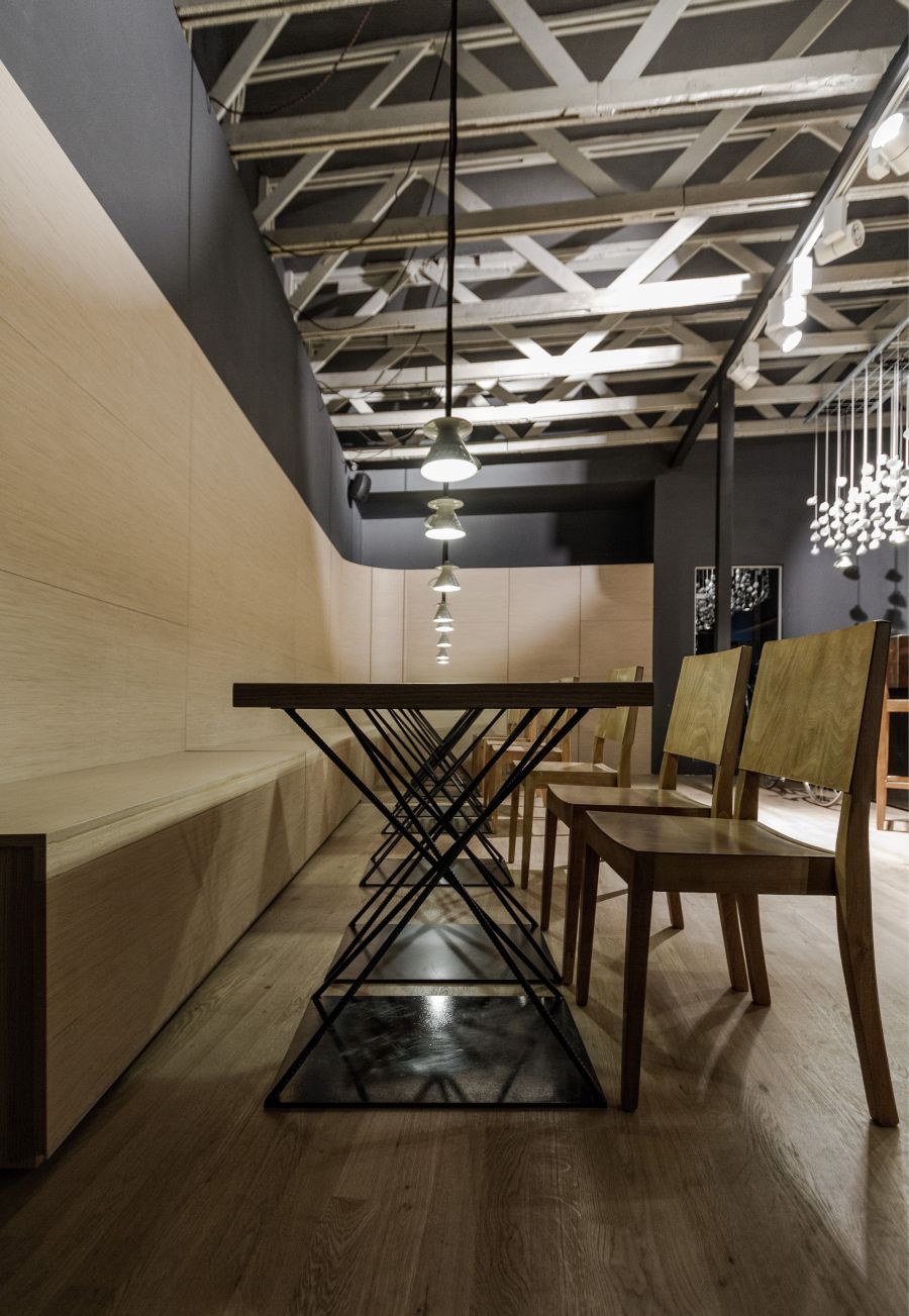 Dining tables with crossed metal rods and oak tops