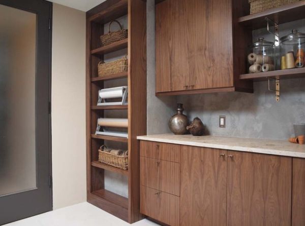 Open shelving with exposed brackets reinforces the industrial look of this laundry room