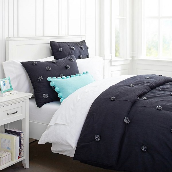 Solid black comforter with pom poms